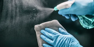 someone sanitizing a surface