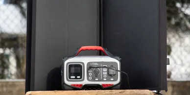 Portable solar generator setup with foldable solar panels charging outdoors.