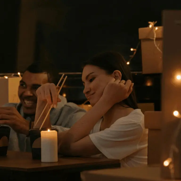people eating food by candlelight during a power outage