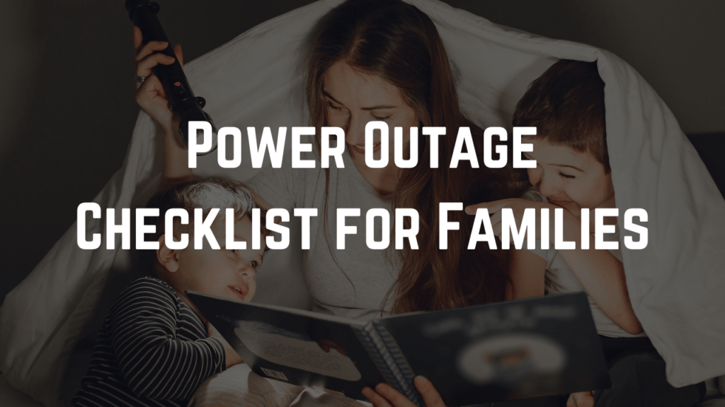 Mother and two children sit under a blanket with a flashlight during a blackout, with the text “Power Outage Checklist for Families” over the image.