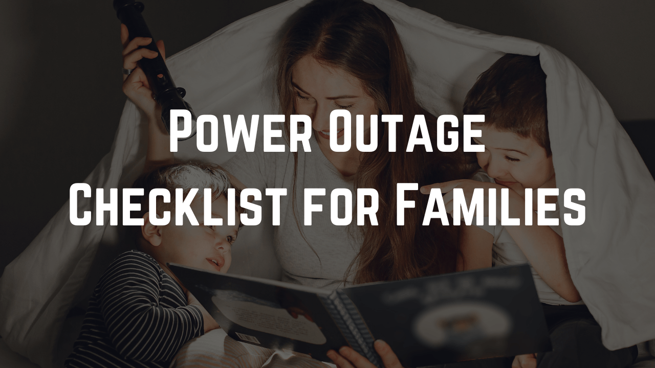 Mother and two children sit under a blanket with a flashlight during a blackout, with the text “Power Outage Checklist for Families” over the image.
